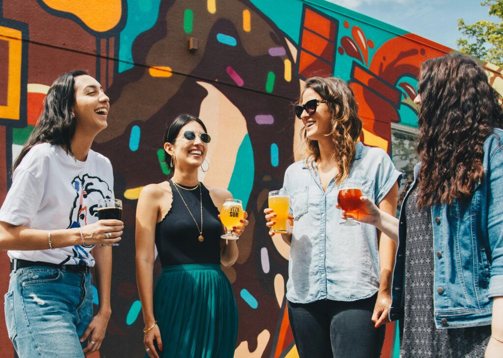 four girls drinking and laughing